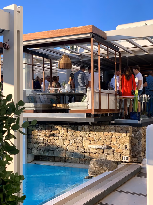 Guests gathered for a poolside cocktail reception at Krama Mykonos