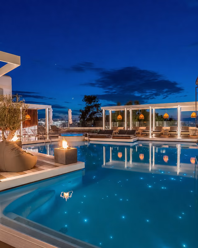 Evening detail of the illuminated Krama rooftop pool and cabanas