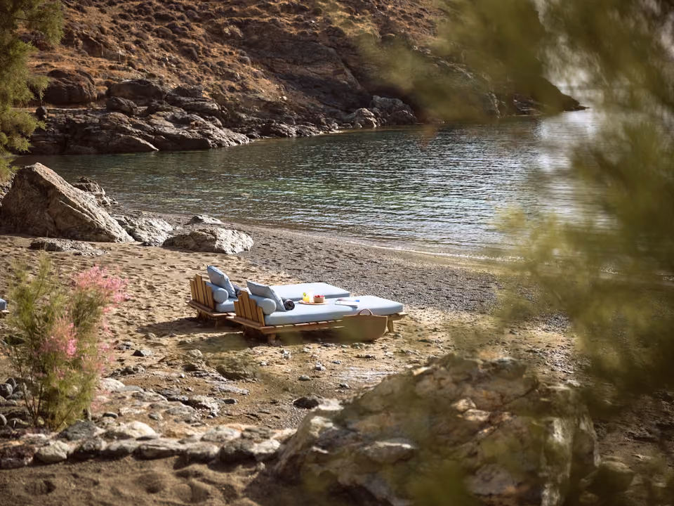 Sunbeds under the tamarisk trees at Merchia Beach, by Almira Taverna