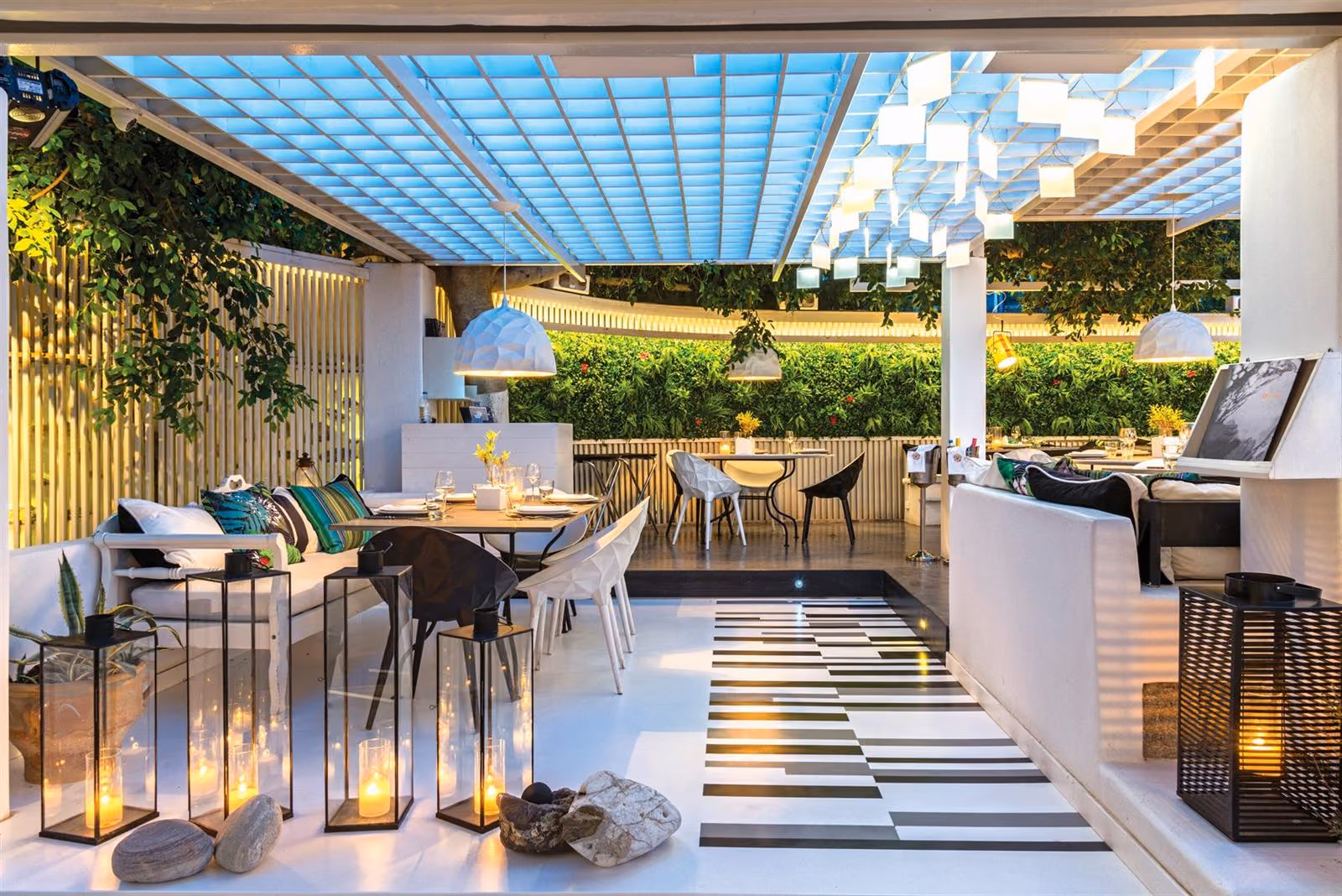 The terrace at Krama in the upper part of Chora, with tables set for dinner and a view over Mykonos Town.