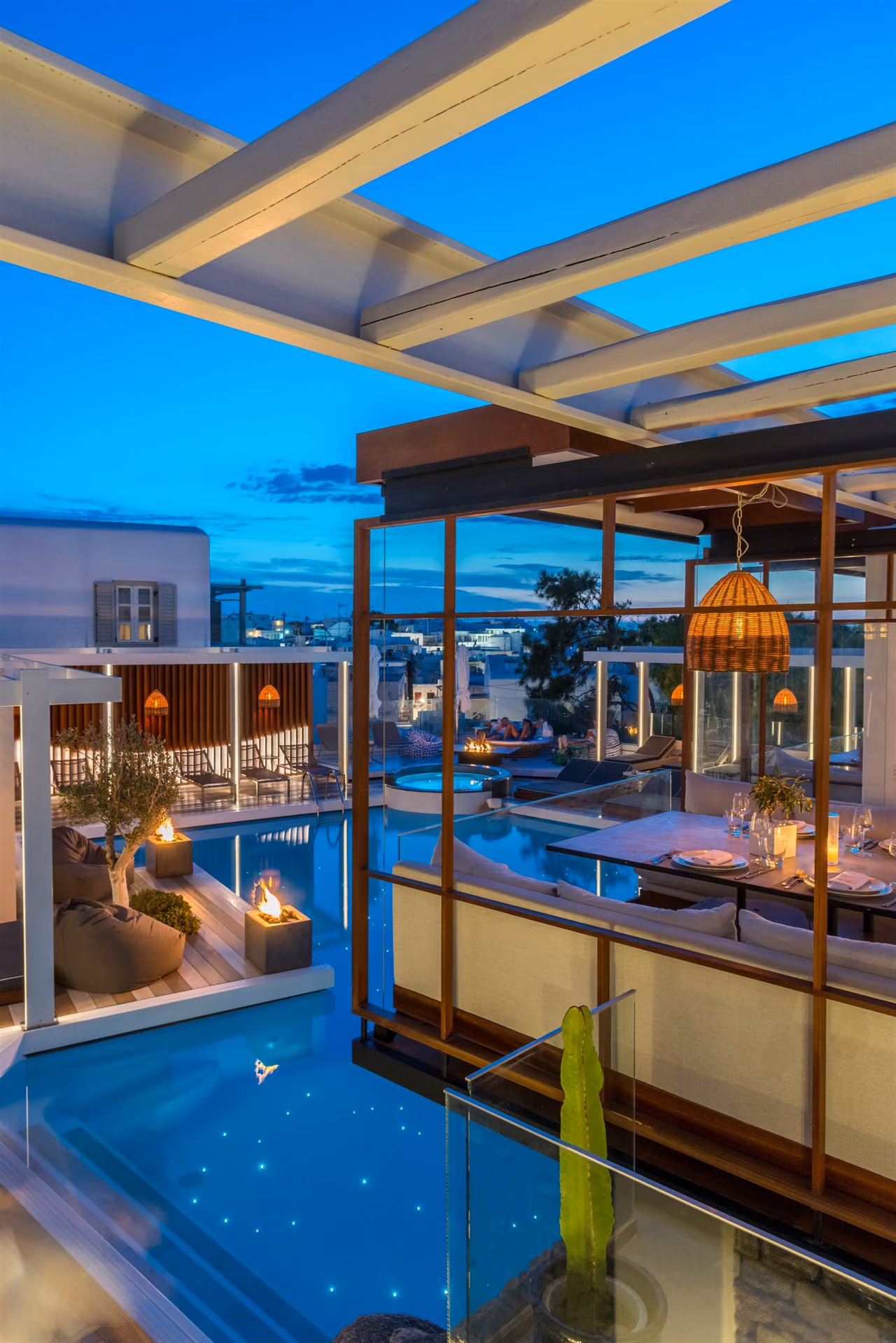Krama pool and glass dining room at dusk