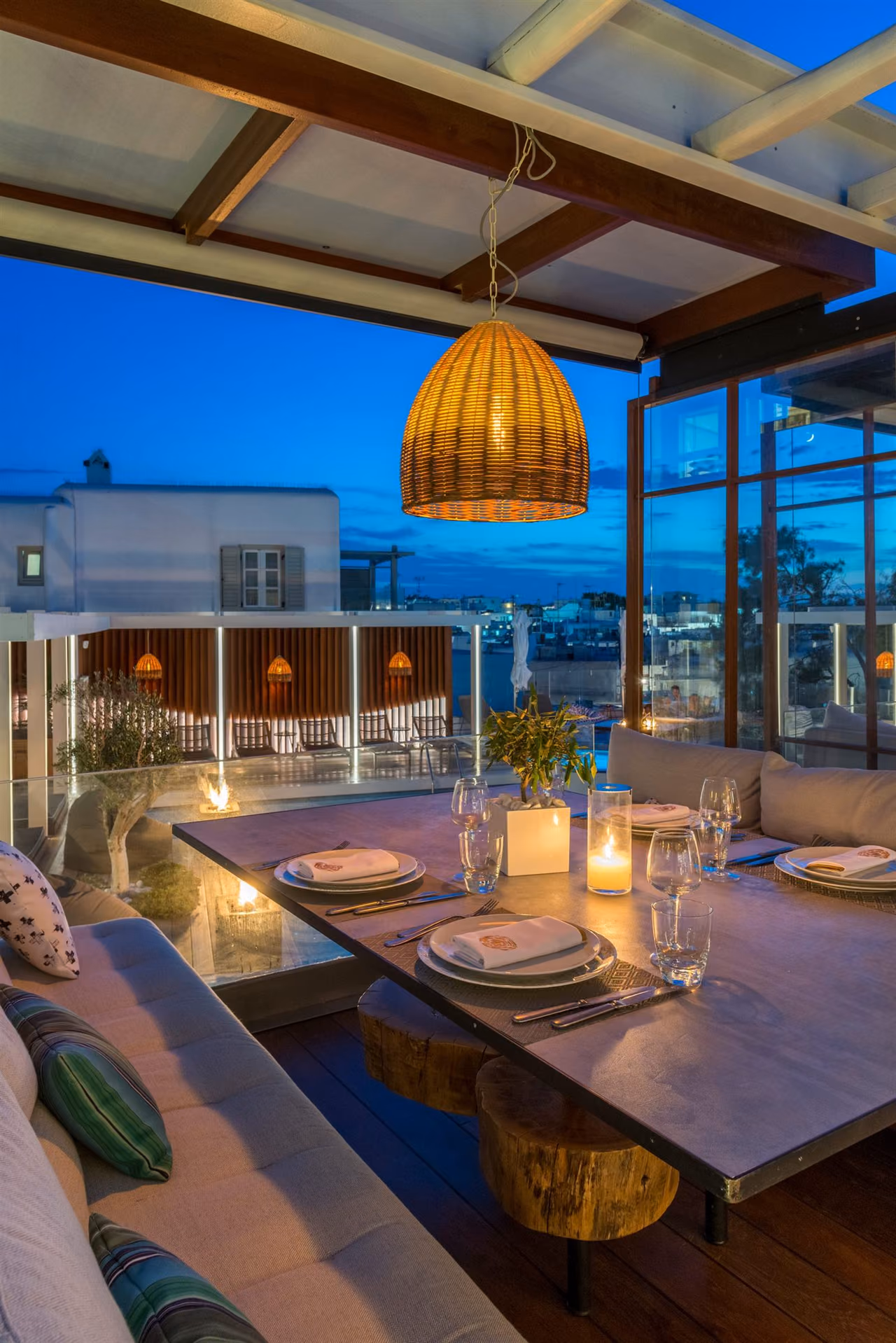A candle-lit table set for a celebration on Krama's rooftop, Mykonos